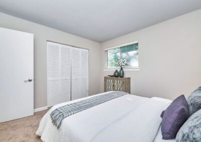 A well-designed kitchen with pristine white cabinets and chic black appliances, offering a striking contrast in decor.